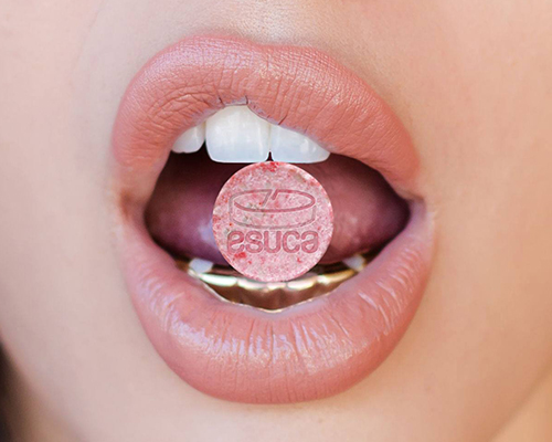 Photo of girls lips with Esuca logo in her mouth